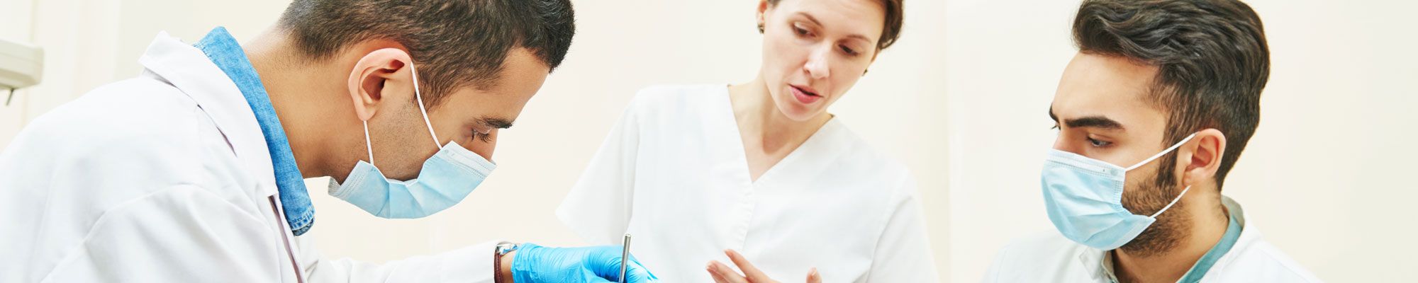 Student dentists watching patient treatment